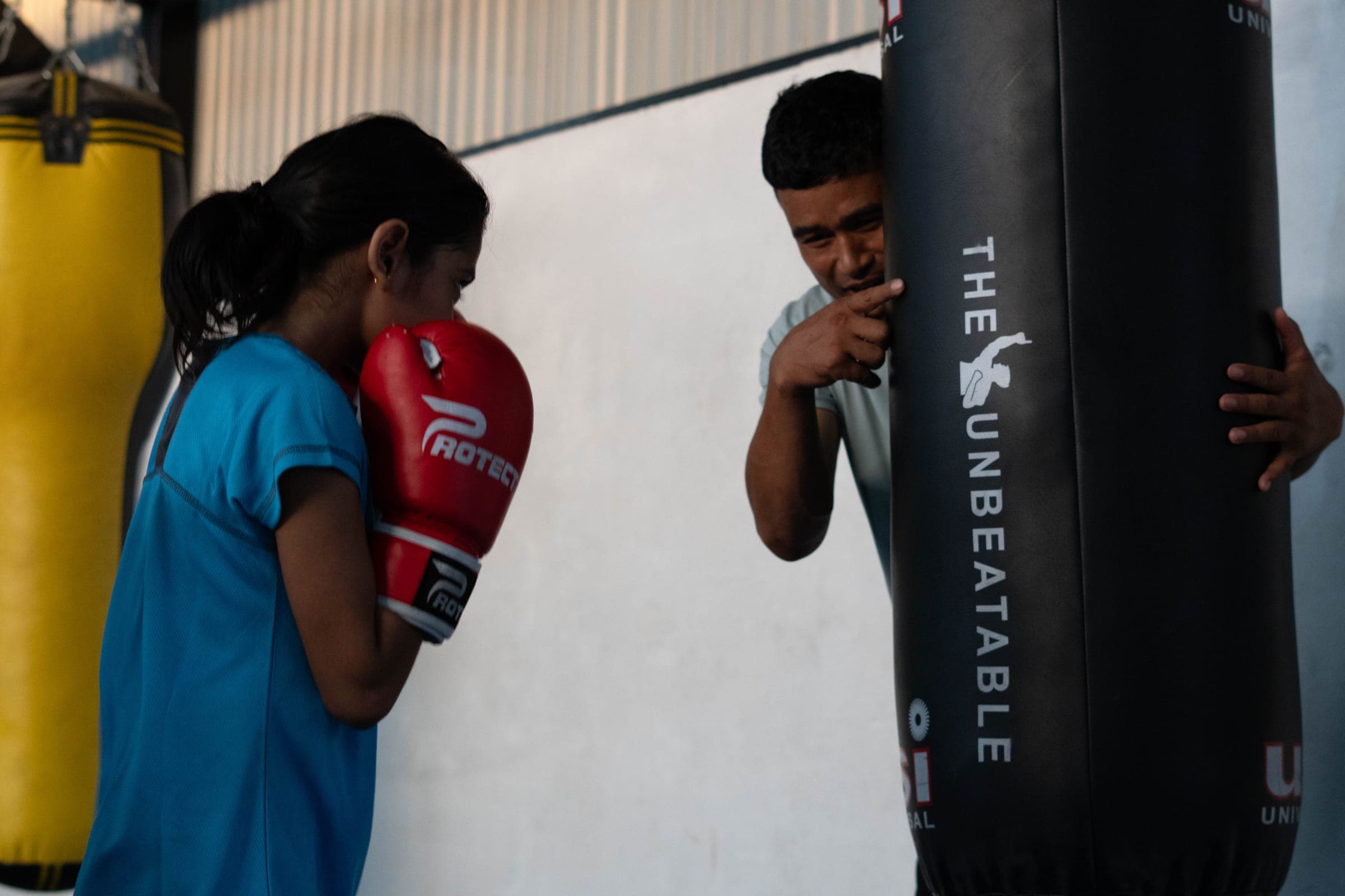 Boxing coach guiding a student at Aspire Sports Academy